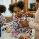 A mother assists her daughter with brushing teeth during a morning routine, fostering hygiene habits.