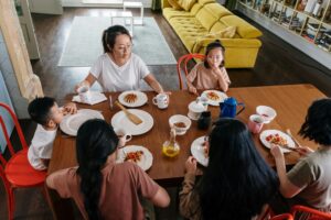 Asian family enjoying breakfast together in a cozy home, fostering togetherness and bonding.